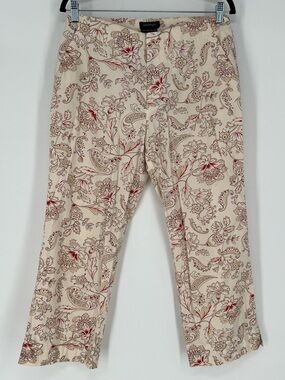 Womyn brand pants in cream fabric with‎ a red and brown paisley floral pattern.